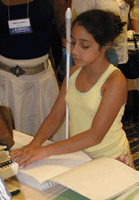 Elora Garcia, age 11, of New York is one of many Braille readers to browse the books offered for free each year at the market.