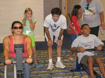 Recreation Division President Lisamaria Martinez (California) to challenged Daniel Brackett (Florida) to an impromptu rowing competition.