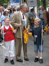 Here Ron Gardner (Utah), Megan Palmer, age 10, (Utah), and Adam Palmer, age 8, (Utah), stop to take in the sounds of the 2007 March for Independence.
