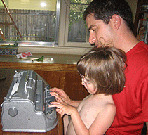 Emilia with her dad, Brandon, at the Braillewriter.