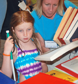 Carrie and Lauren Thomson browsing the Braille Book Flea Market.