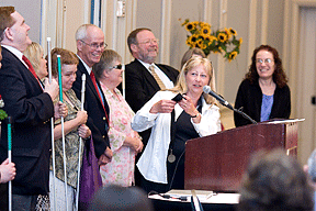 Carrie Gilmer (at the microphone) prepares to present the As the Twig is Bent awards.