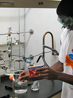 This Youth Slam participant gets a chance to learn how to independently light a Bunsen burner; an essential skill he can take back and use in a high school or college chemistry lab course.