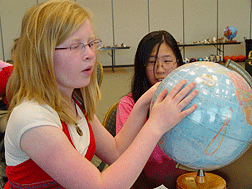 Megan Palmer (UT) examines a tactile globe during a session about astronomy.