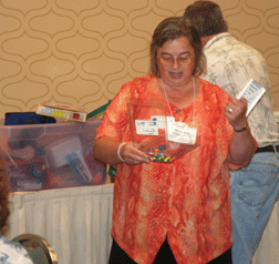 Merry-Noel Chamberlain (VA) leads an NOPBC-sponsored games and toys workshop for parents at the NFB 2008 national convention.