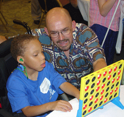 John Trahan (CO) plays a tactile-Braille adapted game with deaf-blind student, Tomas Kline (KY).