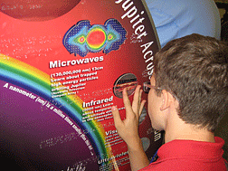 NASA was one of the many important partners that made the 2007 Youth Slam a success. This student examines a NASA tactile/Braille display during one of the programs.