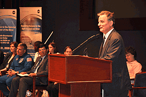 President Maurer addresses Slam participants in the Congressional Auditorium at the US Capitol Visitor Center during the closing ceremony. Special guests from NASA are visible in the background. 