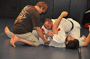 Paralympian Greg DeWall teaches Deaven Tenski, NM, a judo maneuver on Jerald Morlock, MO.
