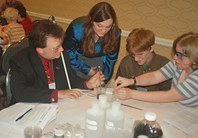 The 2008 chemistry workshop was a big success. Here, April Hill (standing) and Mark Riccobono (left), director of the NFB Jernigan Institute, instruct students David Bouchard and Katie Coulton.