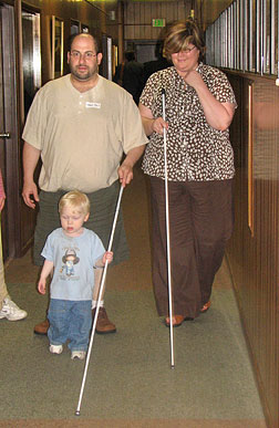 Instructor Amy Phelps leads Marc Fass of New Jersey and his son Andrew on a cane walk at &ldquo;Beginnings and Blueprints.&rdquo;