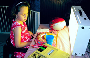 Kendra Holloway sits in front of a light box at breakfast.