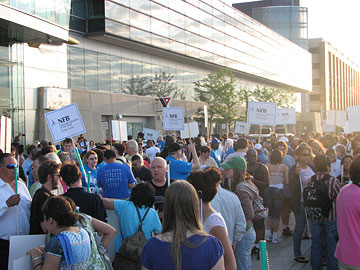 A crowd of Federationists, many holding signs on poles, gathers outside the hotel to begin the 2009 March for Independence.