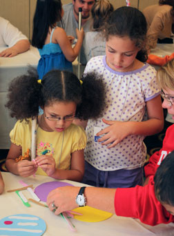 Sisters Elizabeth and Felisha Willis of Virginia examine paper shapes they will use to make a map of the solar system.