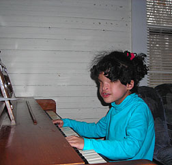 Makaily tries her hand at playing the piano.