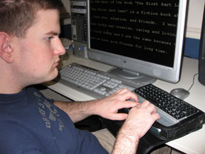 Jon reads from a Braille display hooked to his PC.