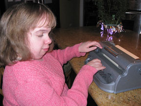 Rachel enjoys writing with her Perkins Brailler.