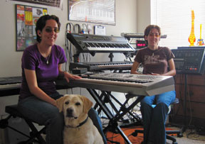 Crystal Morales and her sister Danielle in their music studio; Crystal's guide dog, Umbro, sits beside her