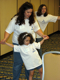 Wearing NOPBC T-shirts, Stephanie Kieszak-Holloway & daughter Kendra do exercises