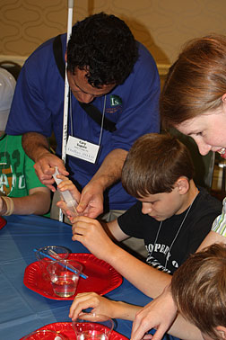 Dr. Cary Supalo directs children during the Digging into Science workshop experiment