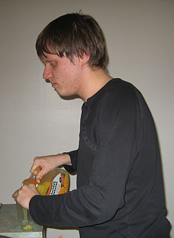Michal Nowicki pours orange juice into a glass.