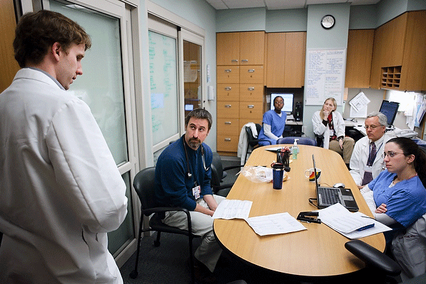 Dr. Tim Cordes shares his thoughts about a particular case while meeting with a team of physicians and medical staff at the UW Hospital and Clinics. [Photo courtesy of photographer Jeff Miller/UW-Madison] 