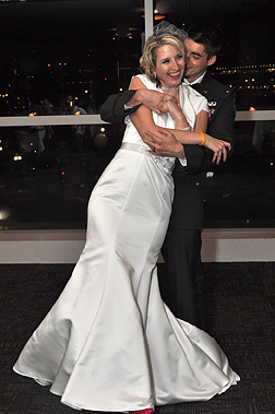 Deja Powell in her wedding gown, smiling with her new husband.