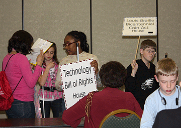 A group of LAW students hold signs for bills the NFB has promoted in Congress.