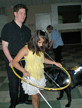 A teacher and student in the Virginia BELL program, Mike and Angela, hold a Hula Hoop while Mike teaches Angela about personal space.