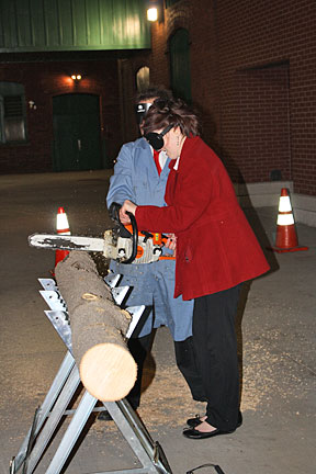 Domonique Lawless uses the chainsaw under sleepshades.
