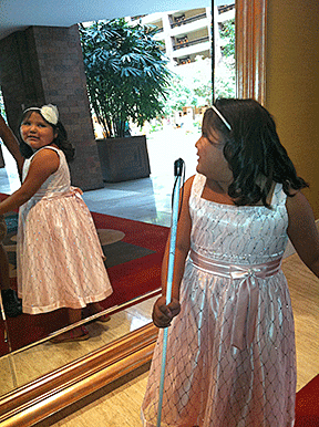 Arianna Benally admires her dress in the mirror.