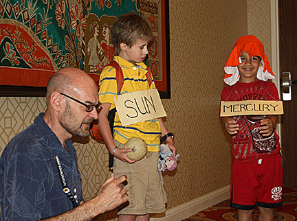 David Hurd leads an activity to help children understand the relationships between the sun and the planets.