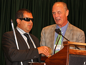 Richie Flores and Jim Gashel at the podium.