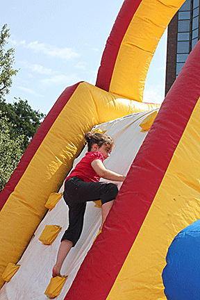 Julia Gebert climbs an air-filled ladder in the inflatable playground at NFB Child Care.