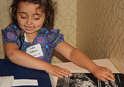 Julia Gebert examines a book about the craters of the moon. 