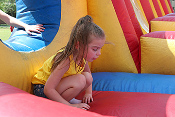 Emma Brown examines the cushioned floor of the bounce house