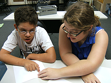 Kaiti Shelton reads Braille with a boy in the Ohio BELL Program.
