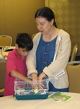 What’s in the cage? Heather Field encourages a young boy to find out.