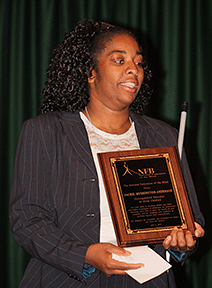 Jackie Mushington-Anderson holding her award