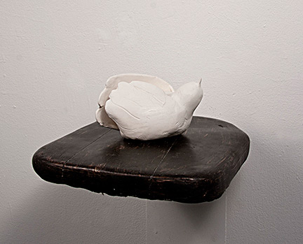 "Sitting Bird" (2012); ceramic and wood.