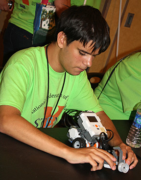 With great concentration, a boy works on his STEM-X project.