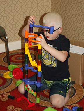 A budding engineer builds a colorful tower.