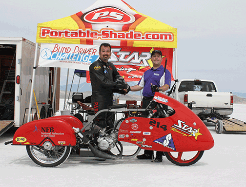 Dan Parker and Mark Riccobono stand beside Dan's motorcycle at the Bonneville Salt Flats.