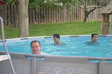 Barbara Hammel in a swimming pool with Paul and Jesse.