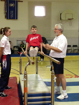 Christopher Roberts swings on the parallel bars.