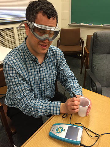 Cary Supalo wearing safety goggles uses a talking LabQuest meter.