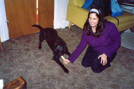 Jo Elizabeth Pinto plays on the floor with her guide dog, Ballad. 