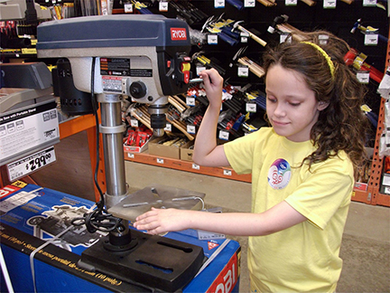 Kendra Holloway examines a drill press.
