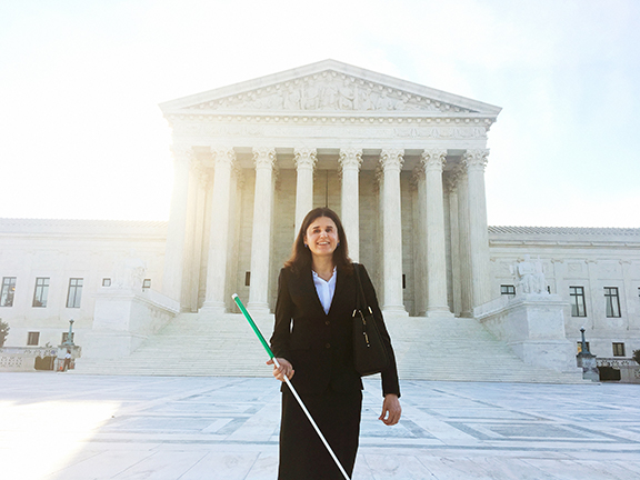 Laura Wolk stands in front of the US Supreme Court building. Read her article: Equal Justice Under Law