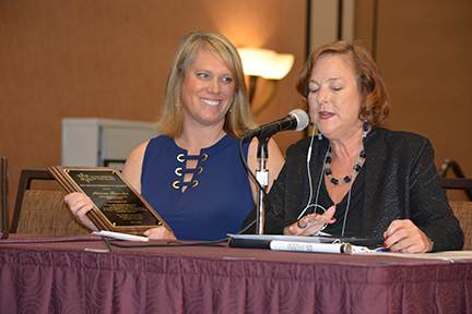 Carla McQuillan presents Adrienne Shoemaker with the 2019 Distinguished Educator Award.